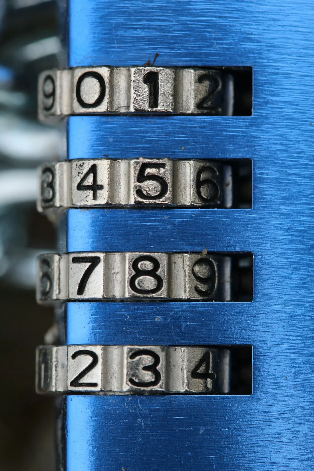 Close-up of a combination padlock dial in blue light